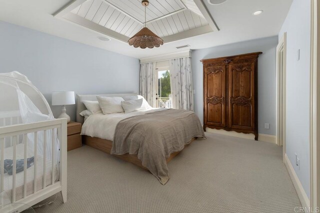 carpeted bedroom featuring access to exterior, baseboards, and visible vents