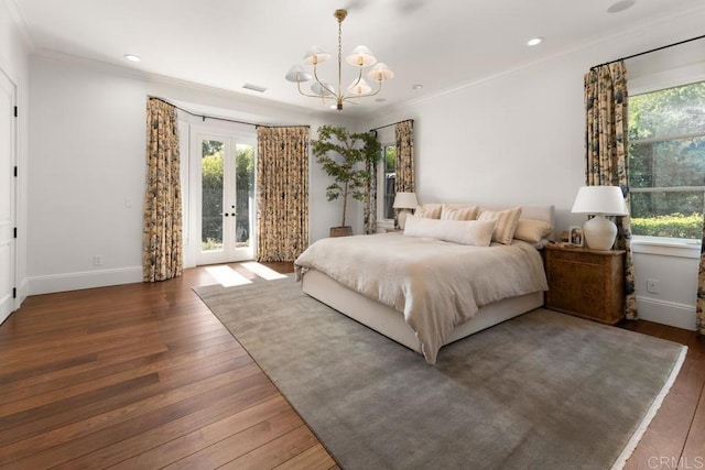 bedroom with crown molding, wood finished floors, access to exterior, french doors, and a notable chandelier