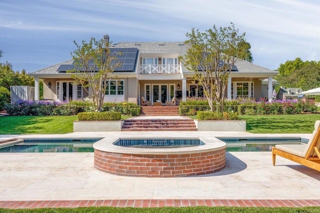16625 Via Lago Azul, Rancho Santa Fe, CA 92067 - back of house with an outdoor pool, roof mounted solar panels, french doors, and a lawn