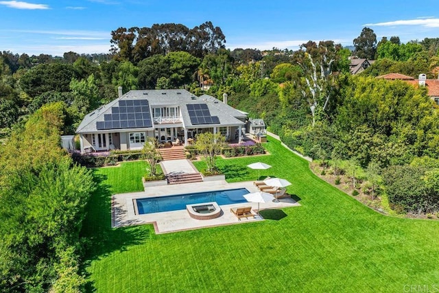 16625 Via Lago Azul, Rancho Santa Fe, CA 92067 - back of house with roof mounted solar panels, a lawn, a patio area, and a wooded view