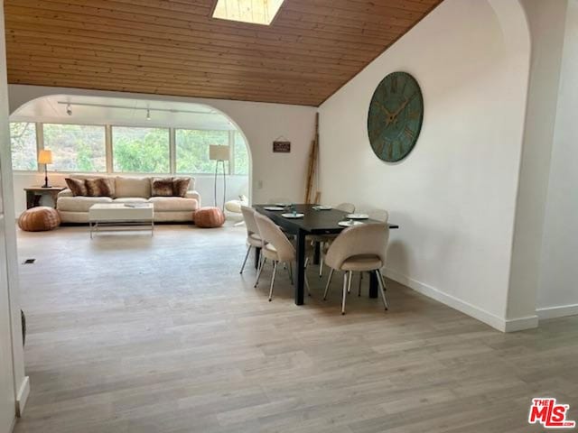 unfurnished dining area featuring wood ceiling, vaulted ceiling, and light hardwood / wood-style flooring