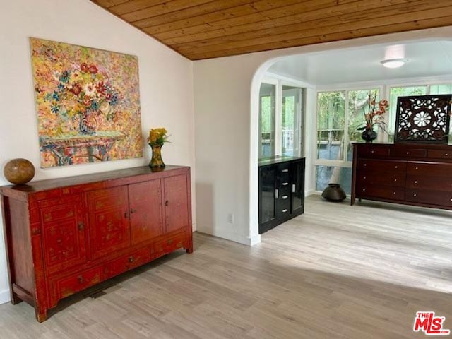 living area with vaulted ceiling, wooden ceiling, and light hardwood / wood-style floors