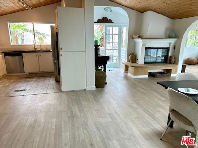 living room with lofted ceiling, sink, wooden ceiling, and light hardwood / wood-style floors