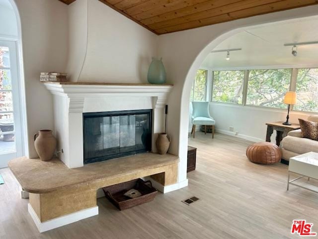 living area with wooden ceiling and light wood-type flooring