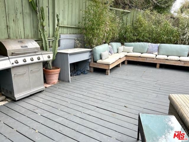 wooden deck featuring an outdoor living space and grilling area