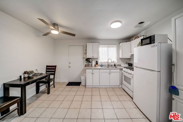 kitchen with sink, white appliances, light tile patterned floors, ceiling fan, and white cabinets