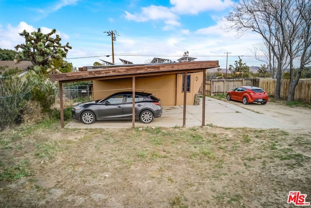 view of parking / parking lot featuring a carport