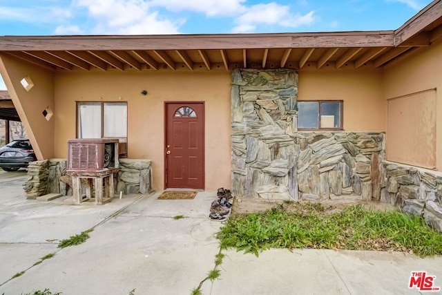 doorway to property with a patio area