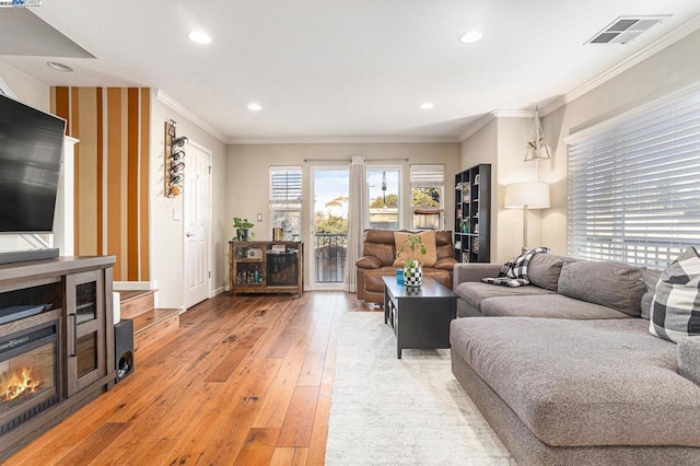 living room with ornamental molding and hardwood / wood-style floors