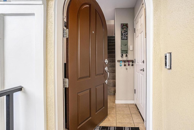 hall with light tile patterned floors