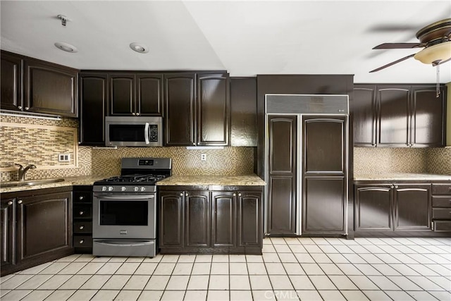 kitchen with sink, decorative backsplash, ceiling fan, stainless steel appliances, and dark brown cabinets