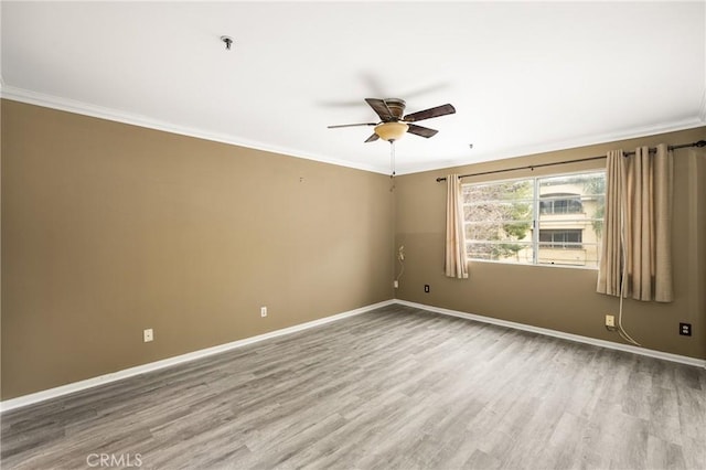 unfurnished room featuring hardwood / wood-style floors, crown molding, and ceiling fan