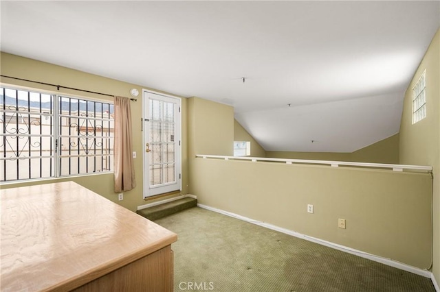 interior space featuring vaulted ceiling and carpet flooring