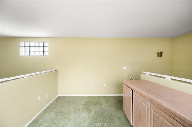 interior space with light brown cabinets and light colored carpet