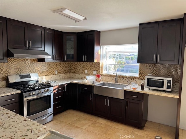 kitchen featuring extractor fan, stainless steel range with gas cooktop, sink, and dark brown cabinets