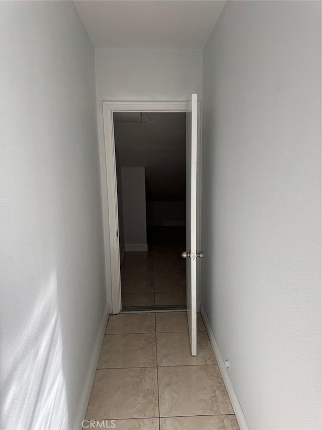 hall featuring light tile patterned floors