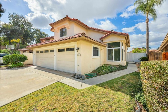 mediterranean / spanish home with a garage and a front yard