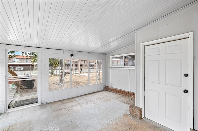 unfurnished sunroom with vaulted ceiling