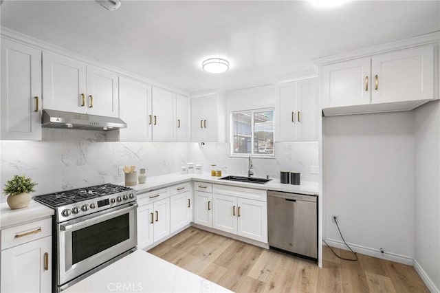 kitchen featuring stainless steel appliances, a sink, white cabinetry, and under cabinet range hood