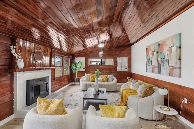 living room with wood walls, wood ceiling, and vaulted ceiling