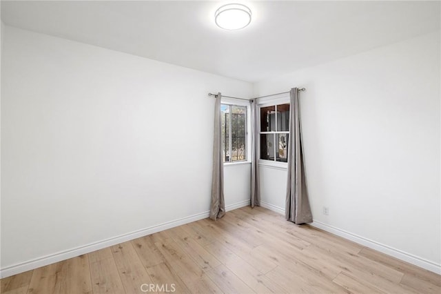 empty room featuring light wood-style floors and baseboards