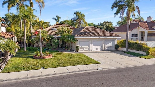 mediterranean / spanish-style house featuring a garage and a front yard