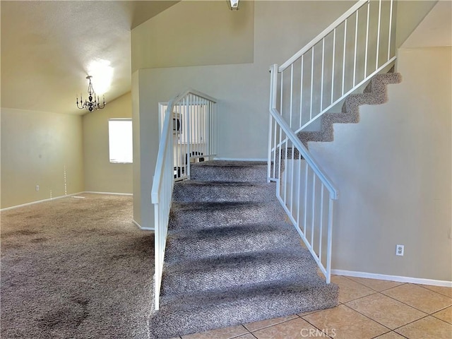 stairway with tile patterned flooring and vaulted ceiling