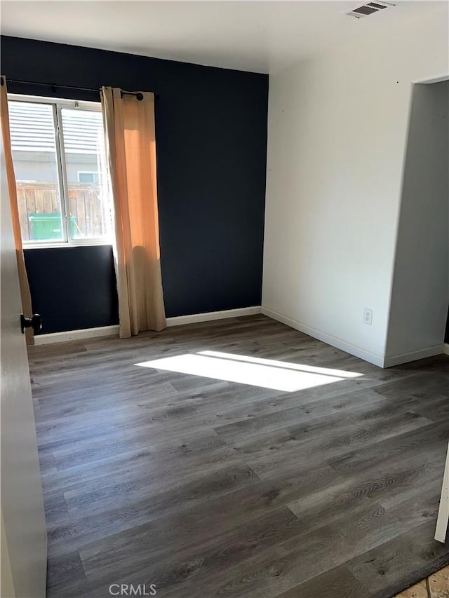 spare room with hardwood / wood-style flooring