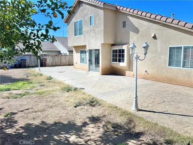 rear view of property featuring a patio area