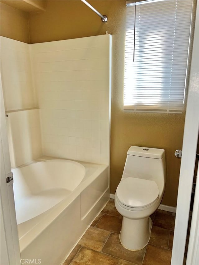 bathroom with shower / tub combination and toilet