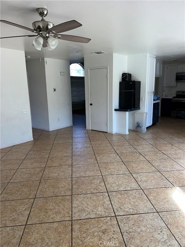 tiled empty room with ceiling fan