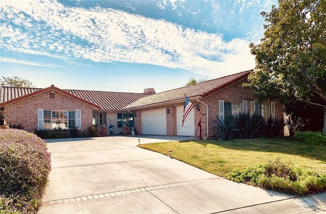 ranch-style home featuring a garage and a front lawn