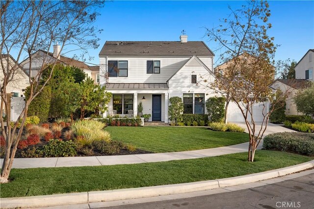 view of front facade featuring a garage and a front lawn