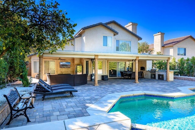 back of house featuring ceiling fan, area for grilling, an outdoor living space, and a patio area