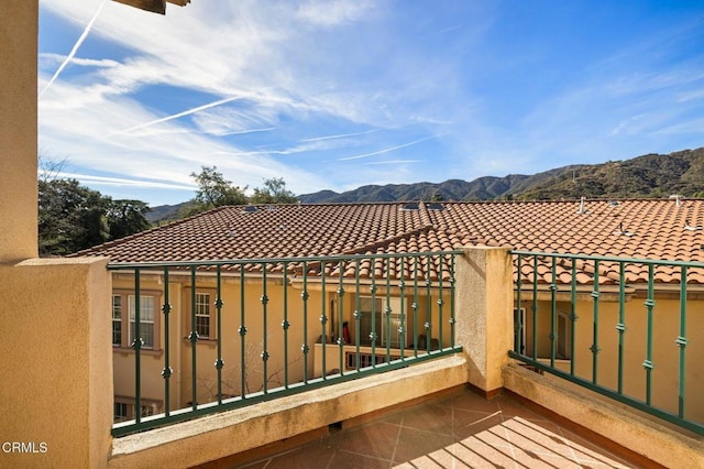 view of patio featuring a mountain view and a balcony