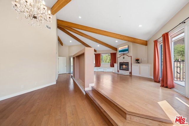 interior space featuring hardwood / wood-style floors, a notable chandelier, and vaulted ceiling with beams