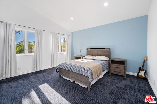 bedroom featuring vaulted ceiling and dark colored carpet