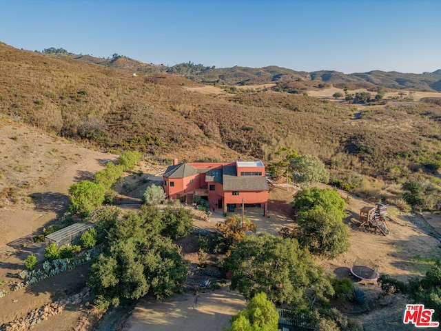 birds eye view of property with a mountain view