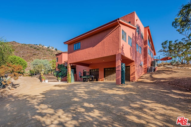 exterior space with a garage and a mountain view