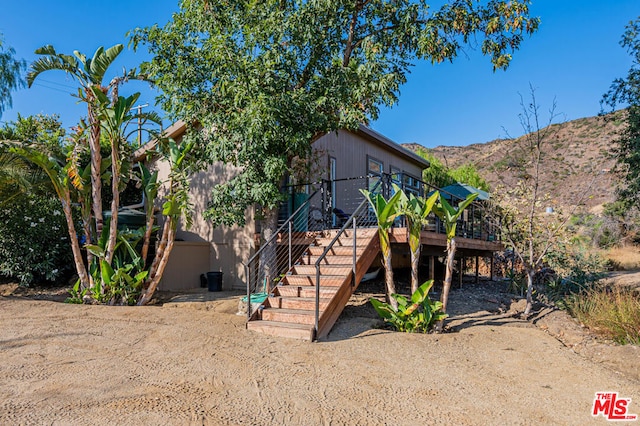 exterior space with a deck with mountain view