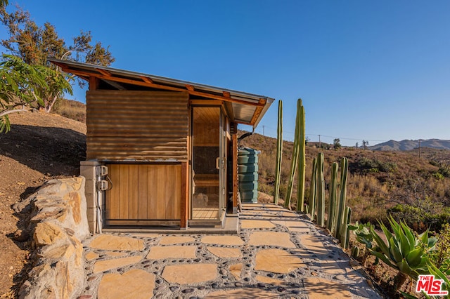 exterior space featuring an outbuilding and a mountain view