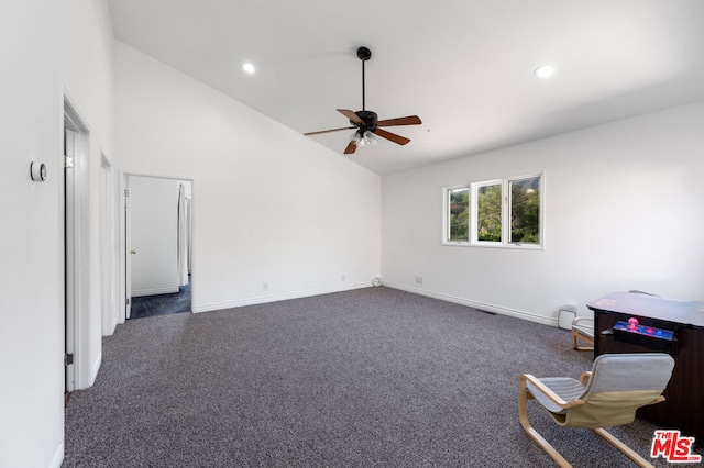 carpeted spare room featuring high vaulted ceiling and ceiling fan