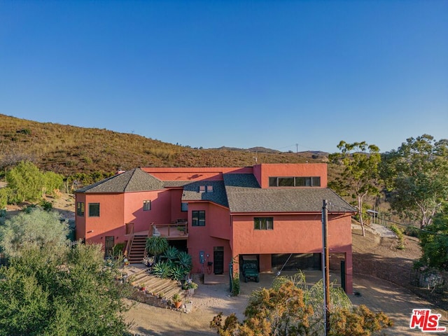 exterior space featuring a deck with mountain view