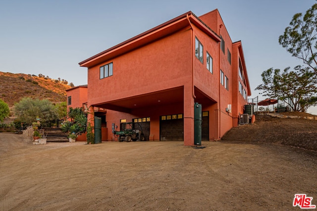 exterior space featuring a garage and central air condition unit