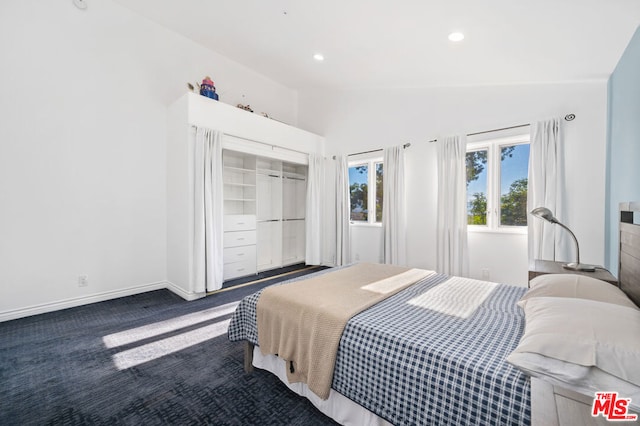 carpeted bedroom with vaulted ceiling