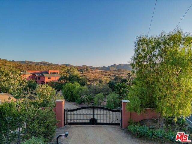 view of gate with a mountain view