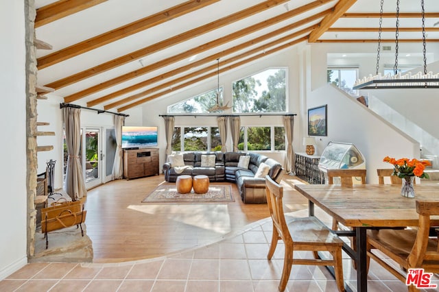 interior space with beam ceiling, high vaulted ceiling, and light tile patterned floors