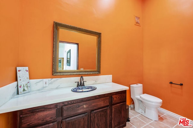 bathroom featuring vanity, tile patterned floors, and toilet