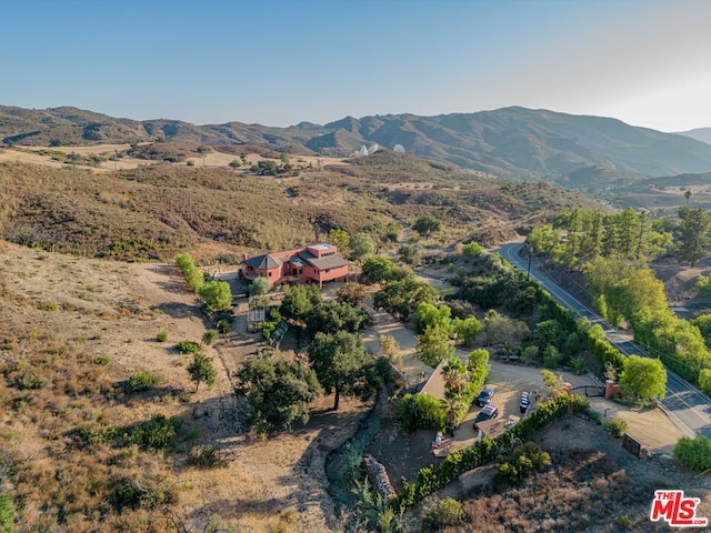 birds eye view of property with a mountain view