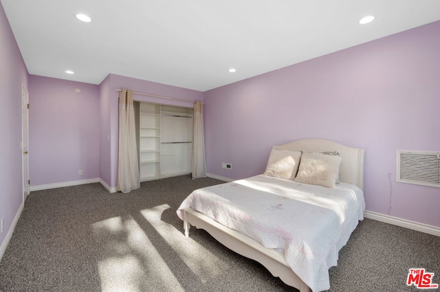 bedroom with dark colored carpet